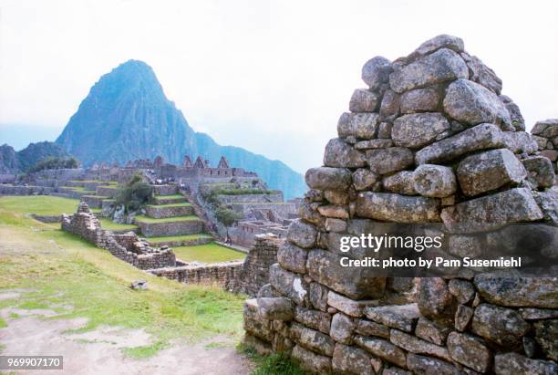 machu picchu wall with view of huayna picchu - berg huayna picchu stock-fotos und bilder