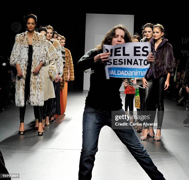 Animals rights campaigners protest against the use of fur in the garments with the slogan "fur is murder" at Jesus Lorenzo show during Cibeles Madrid...