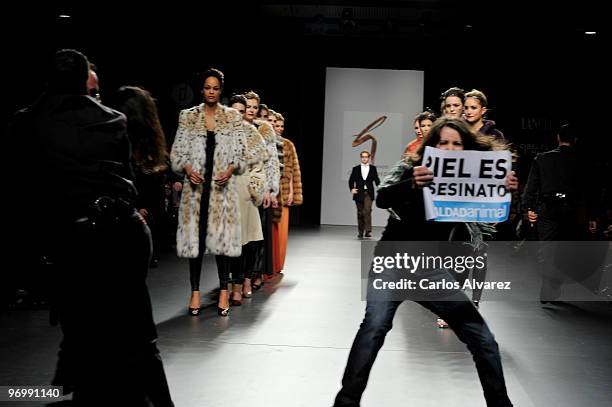 Animals rights campaigners protest against the use of fur in the garments with the slogan "fur is murder" at Jesus Lorenzo show during Cibeles Madrid...