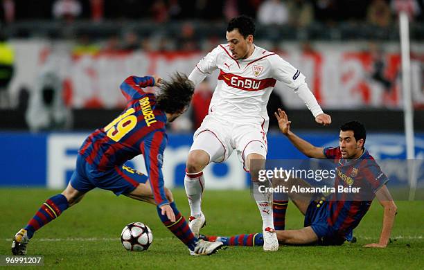 Timo Gebhart of VfB Stuttgart fights for the ball with Sergio Busquets and Maxwell of FC Barcelona during the UEFA Champions League round of sixteen,...