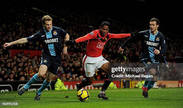 Antonio Valencia of Manchester United battles Jonathan Spector and Alessandro Diamanti of West Ham United during the Barclays Premier League match...