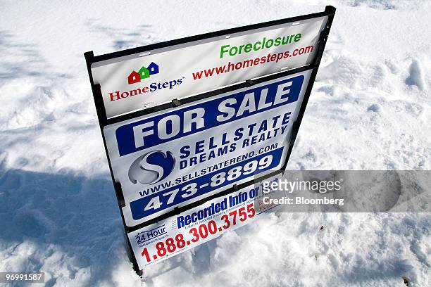 Foreclosure sign sits outside a home for sale in Reno, Nevada, U.S., on Monday, Feb. 22, 2010. A record number of Americans were in danger of losing...