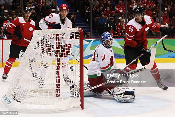 Julien Sprunger of Switzerland scores on a power play against goalkeeper Andrei Mezin of Belarus in the first period during the ice hockey Men's...