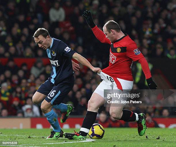 Wayne Rooney of Manchester United clashes with Mark Noble of West Ham United during the FA Barclays Premier League match between Manchester United...