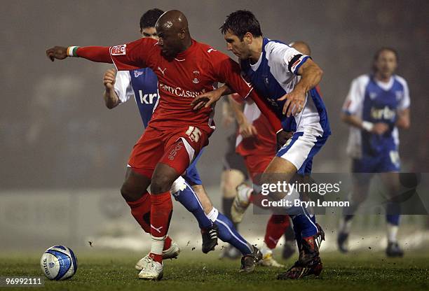 Jonathan Tehoue of Leyton Orient holds off a challenge from Garry Richards of Gillingham during the Coca-Cola Football League One match between...