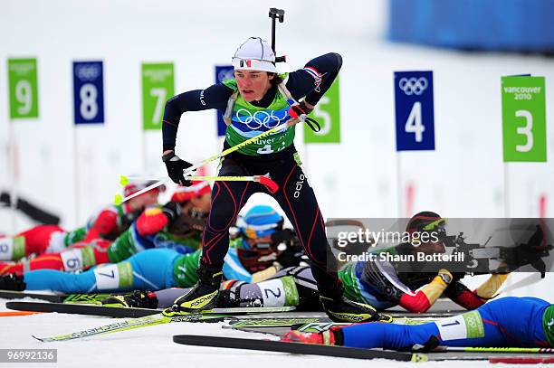 Sylvie Becaert of France gets back on ski after firing in the prone position during the women's biathlon 4 x 6km relay on day 12 of the 2010...