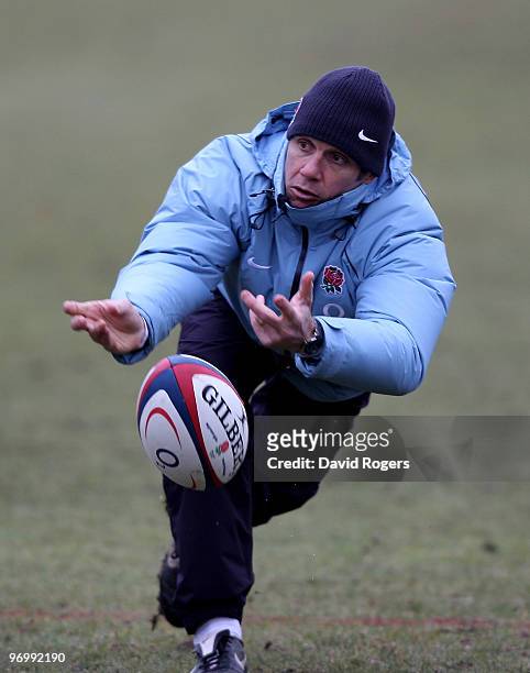 Brian Smith, the England backs coach passes the ball during the England training session held at Pennyhill Park on February 23, 2010 in Bagshot,...