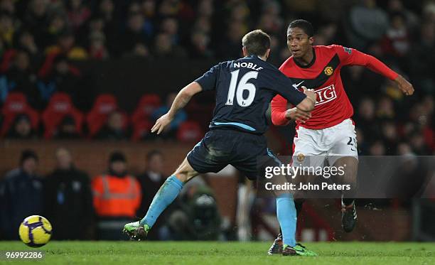 Antonio Valencia of Manchester United clashes with Mark Noble of West Ham United during the FA Barclays Premier League match between Manchester...