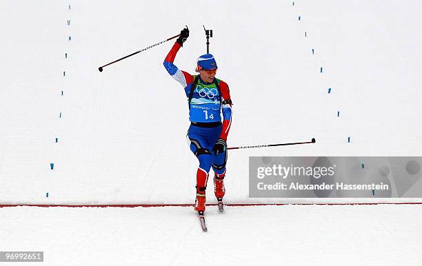 Olga Zaitseva of Russia celebrates crossing the finish line to win the women's biathlon 4 x 6km relay on day 12 of the 2010 Vancouver Winter Olympics...