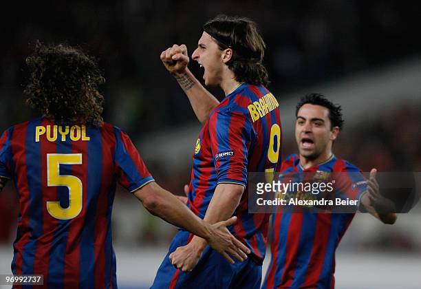 Zlatan Ibrahimovic of FC Barcelona celebrates his first goal with teammates Carles Puyol and Xavi Hernandez during the UEFA Champions League round of...