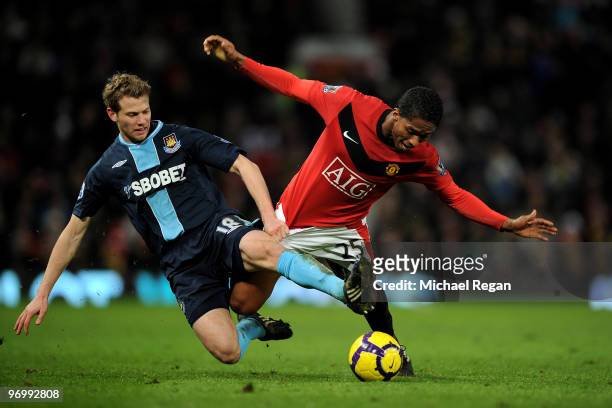 Antonio Valencia of Manchester United battles Jonathan Spector of West Ham United during the Barclays Premier League match between Manchester United...