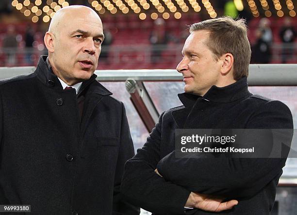 Head coach Christian Gross and manager Horst Heldt talk to each other prior to the UEFA Champions League round of sixteen, first leg match between...