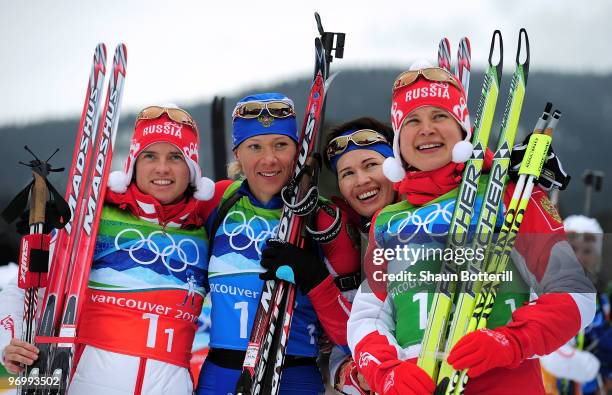 Svetlana Sleptsova, Olga Zaitseva, Olga Medvedtseva and Anna Bogaliy-Titovets of Russia celebrate after winning the gold medal during the women's...