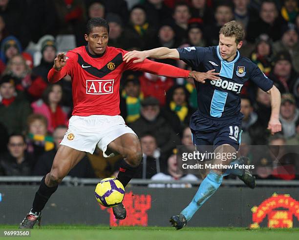Antonio Valencia of Manchester United clashes with Jonathan Spector of West Ham United during the FA Barclays Premier League match between Manchester...