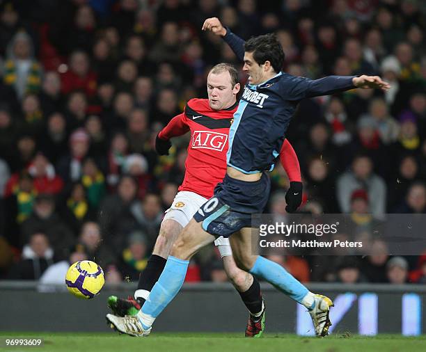 Wayne Rooney of Manchester United clashes with Guillermo Franco of West Ham United during the FA Barclays Premier League match between Manchester...