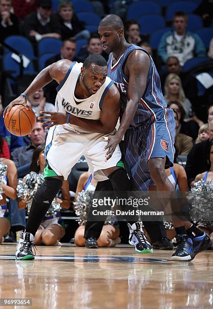 Al Jefferson of the Minnesota Timberwolves handles the ball against Nazr Mohammed of the Charlotte Bobcats during the game on February 10, 2010 at...