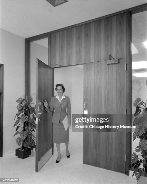 Interior view of the corporate headquarters of the Morton Salt Company, located at 110 North Wacker Drive, showing a woman walking through one of the...