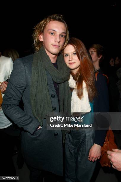 Jamie Campbell Bower and Bonnie Wright pose on the front row at the Burberry Prorsum show for London Fashion Week Autumn/Winter 2010 at on February...