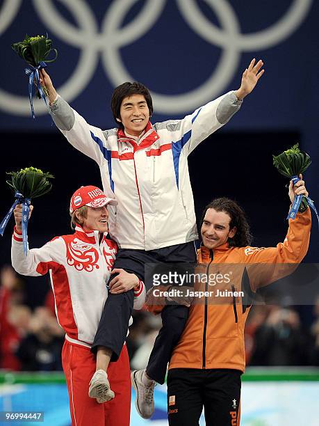 Ivan Skobrev of Russia celebrates winning silver, Lee Seung-Hoon of South Korea gold and Bob De Jong of Netherlands bronze during the flower ceremony...
