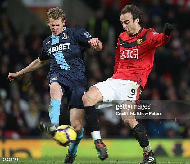 Dimitar Berbatov of Manchester United clashes with Jonathan Spector of West Ham United during the FA Barclays Premier League match between Manchester...