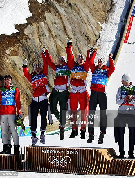Wolfgang Loitzl, Andreas Kofler, Thomas Morgenstern and Gregor Schlierenzauer of Austria celebrate their gold medal in the men's ski jumping team...