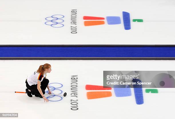 Stella Heiss of Germany watches her stone slide down the sheet during the women's curling round robin game between Germany and Switzerland on day 12...