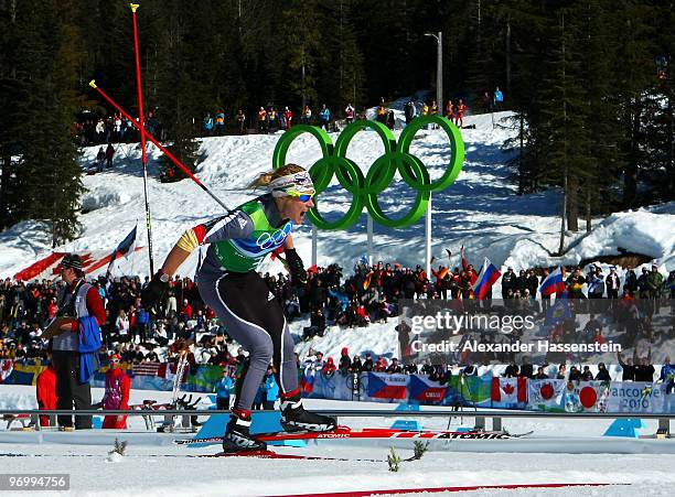 Claudia Nystad of Germany celebrates as she crosses the finish line to win the gold medal during the cross country skiing ladies team sprint final on...