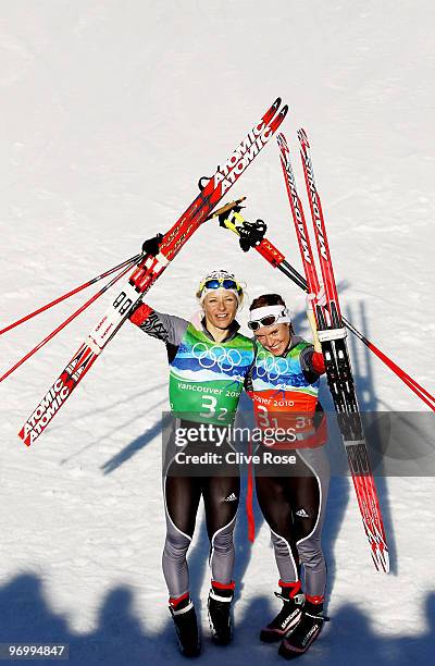 Claudia Nystad and Evi Sachenbacher-Stehle of Germany celebrate crossing winning the gold medal in the cross country skiing ladies team sprint final...