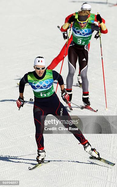 Laure Barthelemy of France and Claudia Nystad of Germany compete during the cross country skiing ladies team sprint semifinal on day 11 of the 2010...