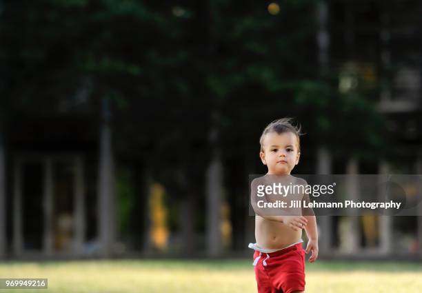 2 year old toddler walks confidently in public urban park - year in focus sport ストックフォトと画像