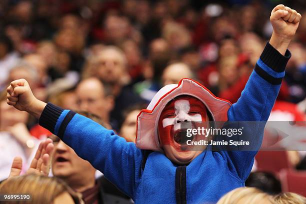 Swiss fan cheers during the ice hockey Men's Qualification Playoff game between Switzerland and Belarus on day 12 of the Vancouver 2010 Winter...