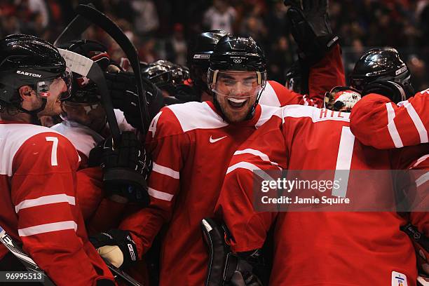 Mark Streit, Philippe Furrer and Jonas Hiller of Switzerland celebrate winning the ice hockey Men's Qualification Playoff game between Switzerland...