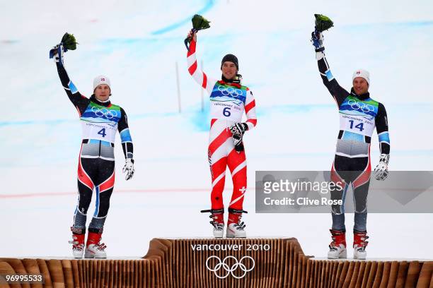 Silver medalist Kjetil Jansrud of Norway, gold medalist Carlo Janka of Switzerland and bronze medalist Aksel Lund Svindal of Norway celebrate after...