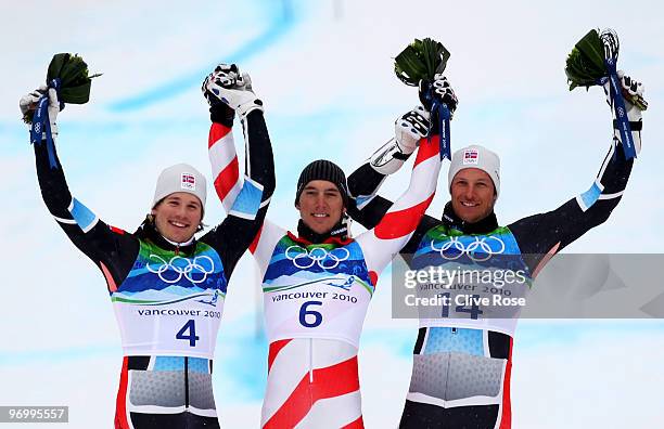 Silver medalist Kjetil Jansrud of Norway, gold medalist Carlo Janka of Switzerland and bronze medalist Aksel Lund Svindal of Norway celebrate after...