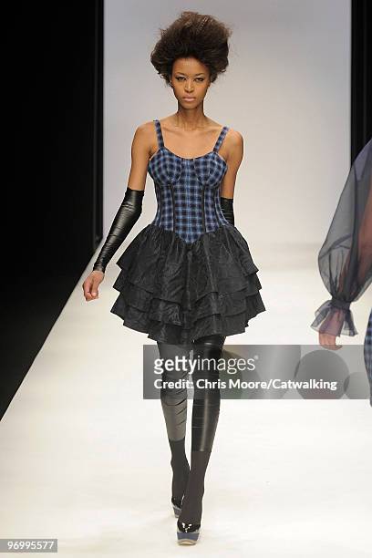 Model walks down the runway during the Paul Costelloe fashion show, part of London Fashion Week, London on February 19, 2010 in London, England.