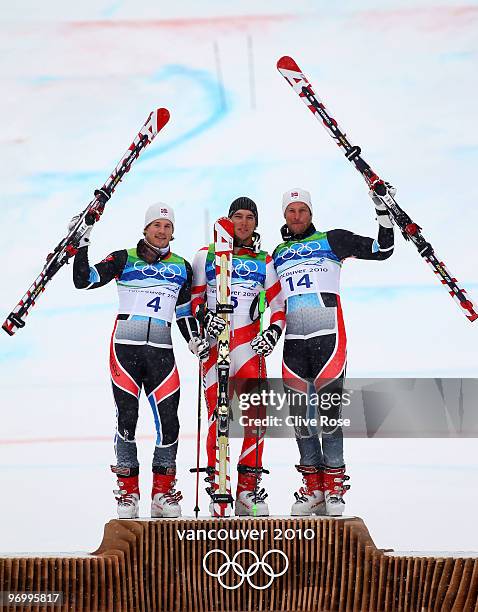 Silver medalist Kjetil Jansrud of Norway, gold medalist Carlo Janka of Switzerland and bronze medalist Aksel Lund Svindal of Norway celebrate after...