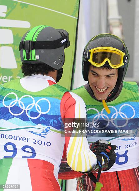 Senegal's Leyti Seck and Morocco's Samir Azzimani look on in the finish area during the men's giant slalom race of the Vancouver 2010 Winter Olympics...