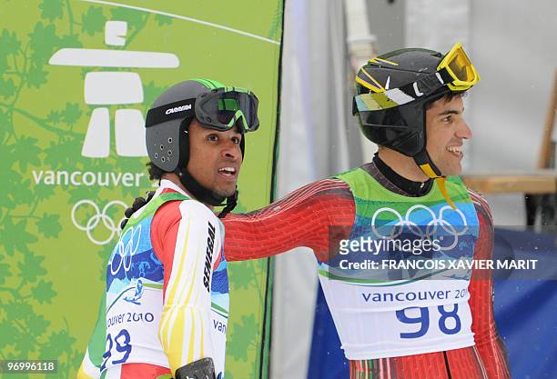 Senegal's Leyti Seck and Morocco's Samir Azzimani look on in the finish area during the men's giant slalom race of the Vancouver 2010 Winter Olympics...