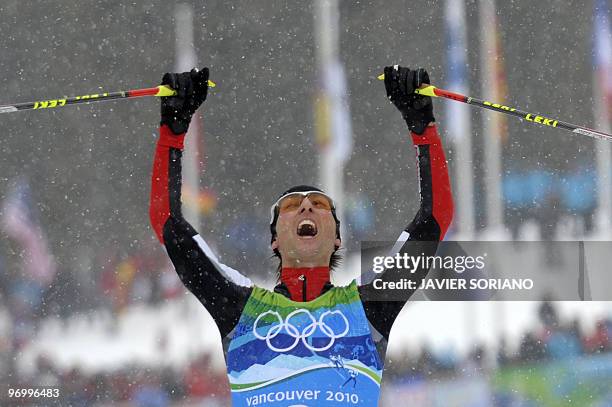 Austria's Mario Stecher reacts as he crosses the finish as he competes in the men's Nordic Combined team 4x5 km at the Whistler Olympic Park during...