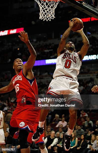 Acie Law of the Chicago Bulls shoots past Marreese Speights of the Philadelphia 76ers at the United Center on February 20, 2010 in Chicago, Illinois....