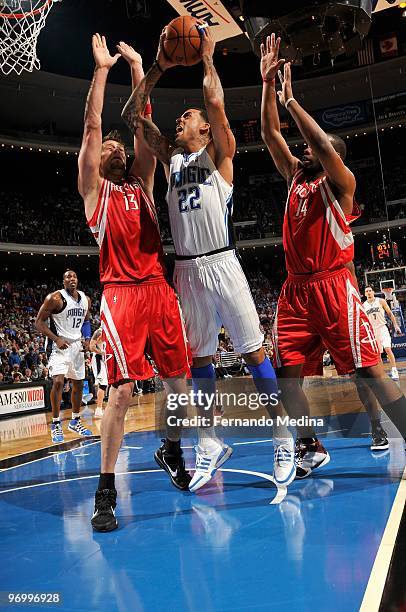 Matt Barnes of the Orlando Magic looks to score against David Andersen and Carl Landry of the Houston Rockets during the game on December 23, 2009 at...