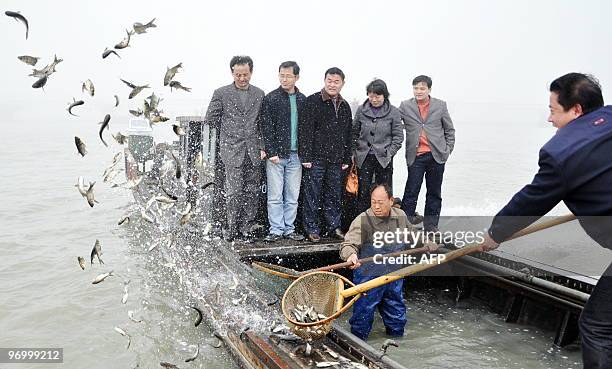 Chinese officials release algae-eating fish into Taihu Lake in Suzhou, east China's Jiangsu province on February 23 which has been severely polluted...