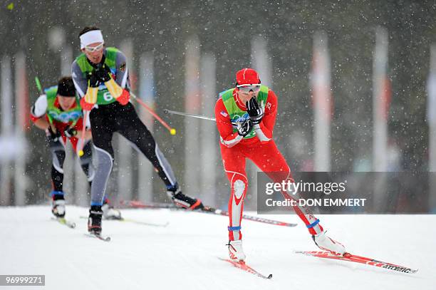 Todd Lodwick of the US and Germany's Tino Edelmann compete in the men's Nordic Combined team 4x5 km at the Whistler Olympic Park during the Vancouver...