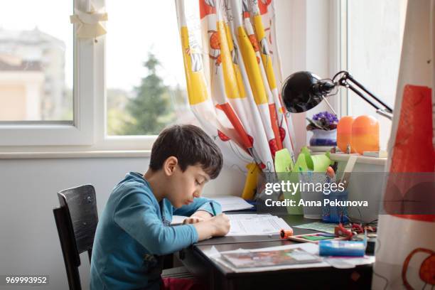 young boy doing maths at home - anna pekunova stock-fotos und bilder