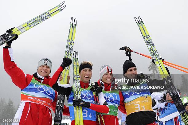 Austria's Bernhard Gruber and teammates Mario Stecher, David Kreiner and Felix Gottwald react after the men's Nordic Combined team 4x5 km at the...