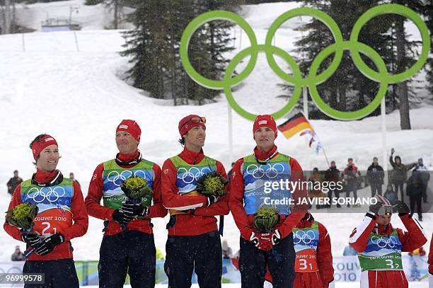 Silver medalists of the US Brett Camerota, Todd Lodwick, Johnny Spillane and Bill Demong attend the podium ceremony in the men's Nordic Combined team...