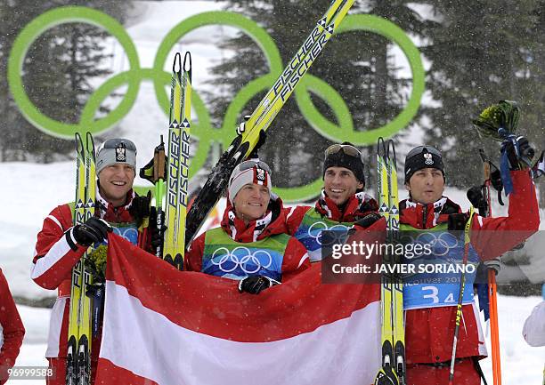 Austria's Bernhard Gruber, Austria's David Kreiner, Austria's Felix Gottwald and Austria's Mario Stecher attend the podium ceremony the men's Nordic...