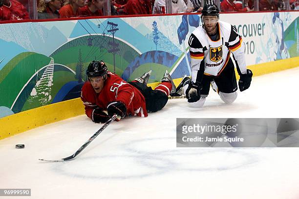 Ryan Getzlaf of Canada fights for the puck against Sven Felski of Germany during the ice hockey Men's Qualification Playoff game between Germany and...