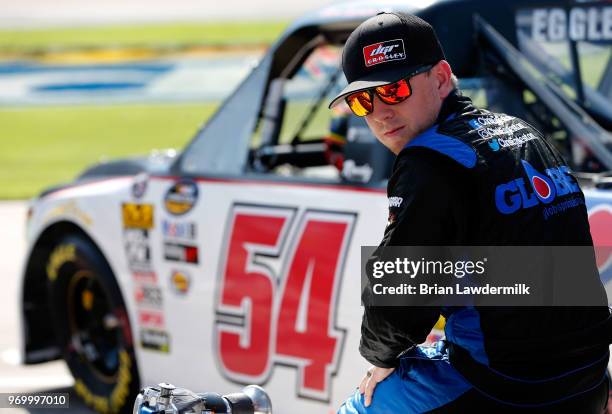 Chris Eggleston, driver of the GlobeSprinkler.com/H2O Fire Protection Inc., stands on the grid during the US Concrete Qualifying Day for the NASCAR...