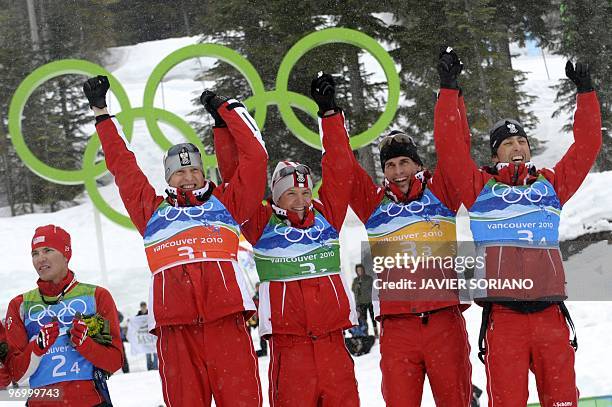 Austria's gold medal winners Bernhard Gruber, David Kreiner, Felix Gottwald and Mario Stecher attend the podium ceremony in the men's Nordic Combined...